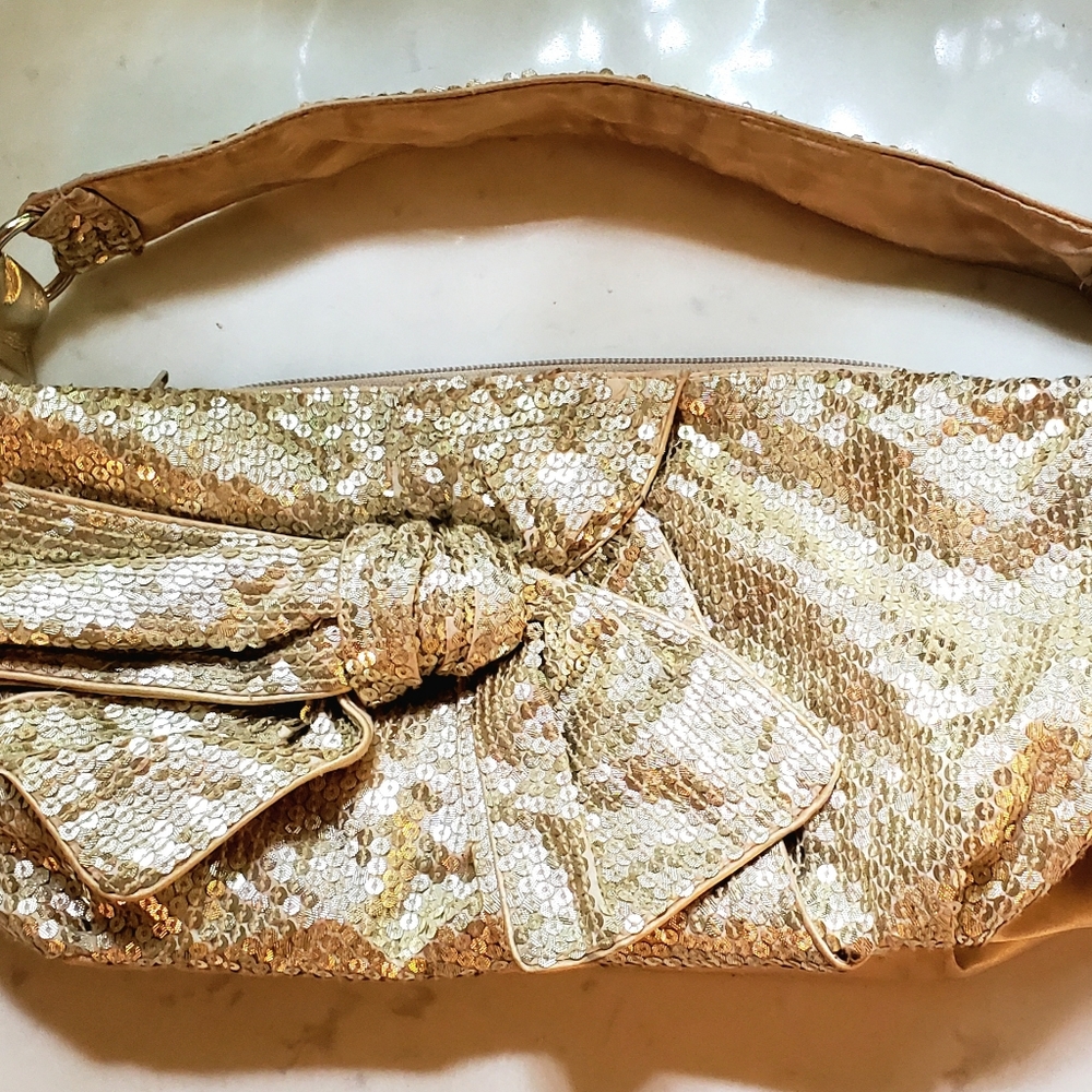Gold sequin shoulder bag with front bow design